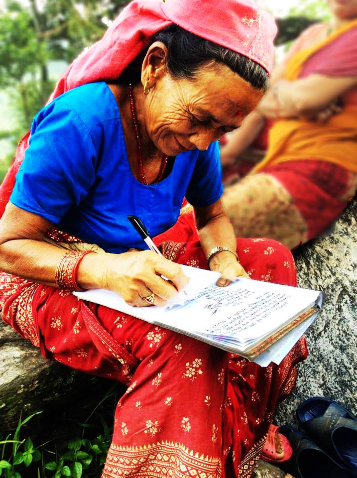 Community partner in Nepal standing outdoors in a rural setting.